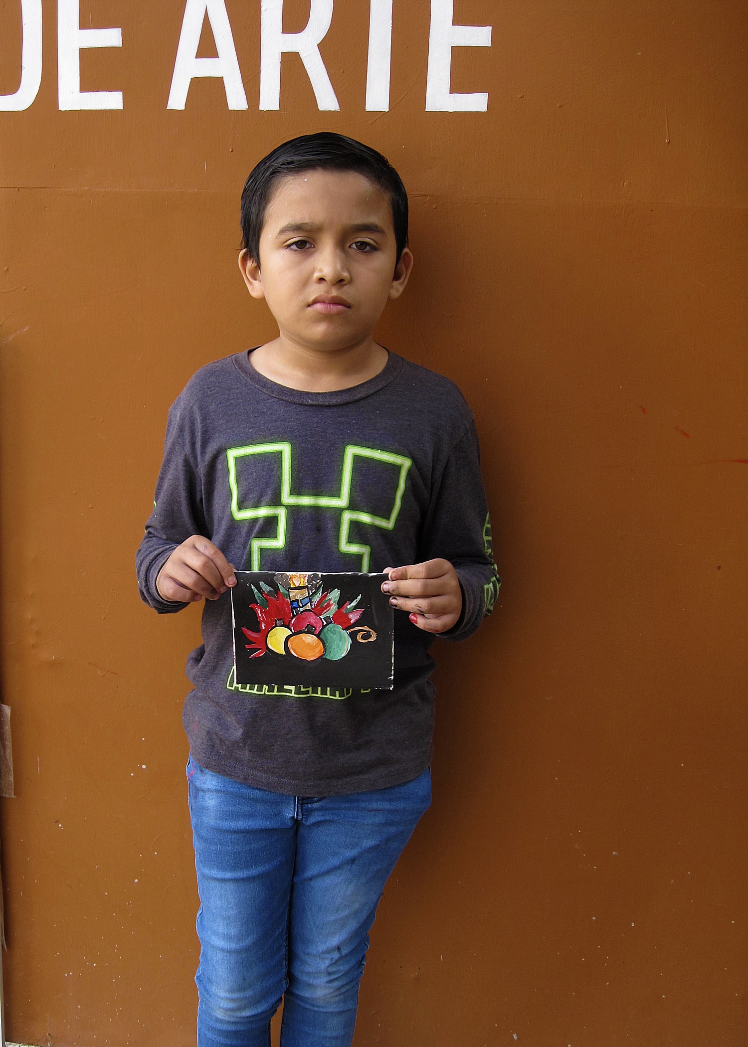 Young artist showing off art